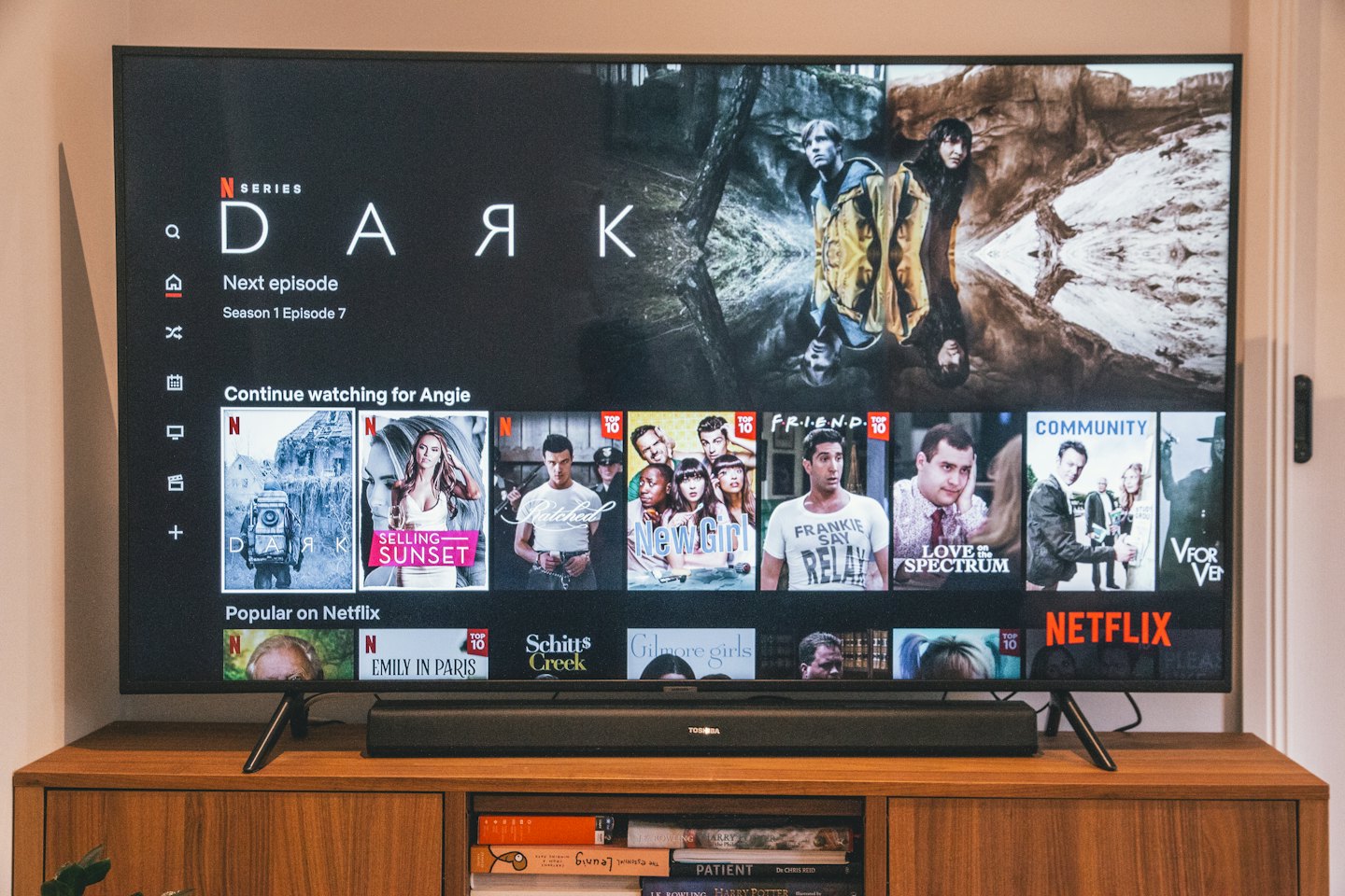 Black smart TV displaying Netflix interface with 'Dark' series.