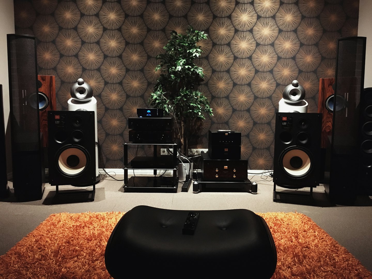 High-end audio system with speakers and amplifiers in a decorated room.